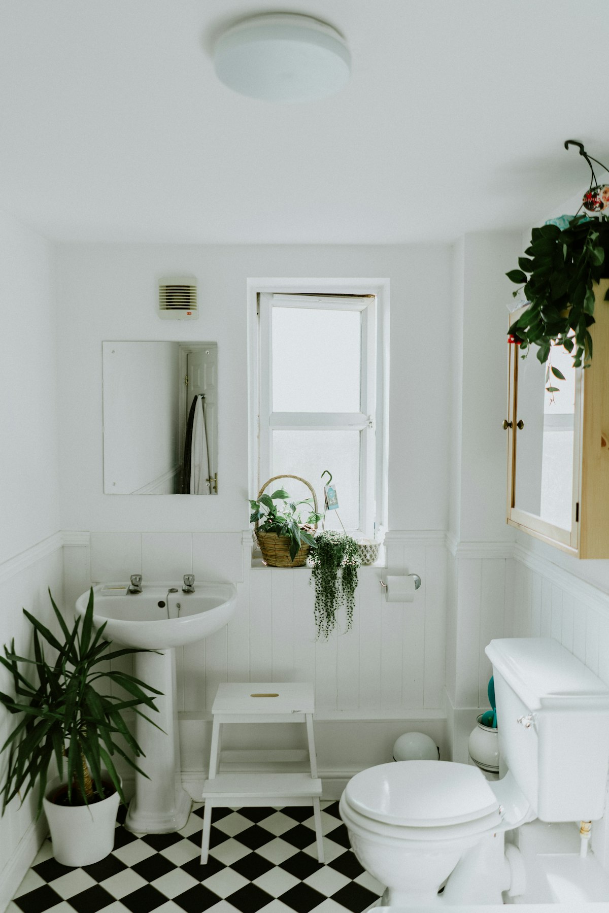 White bathroom with a pedestal sink